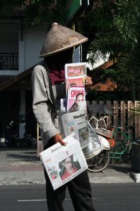 person selling newspapers