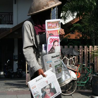 person selling newspapers