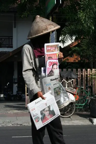 person selling newspapers