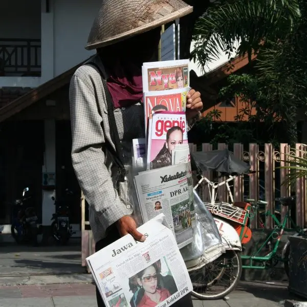 person selling newspapers