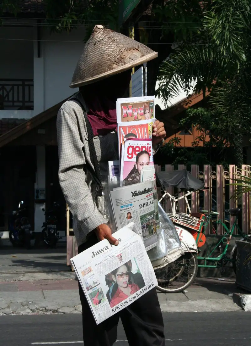 person selling newspapers