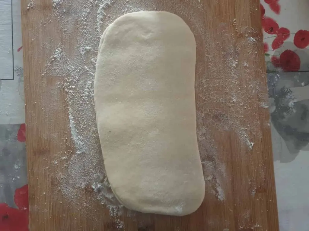 Rolling out the dough lengthwise