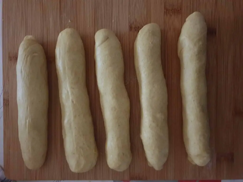 Pre-shaped bread sausages before shaping them