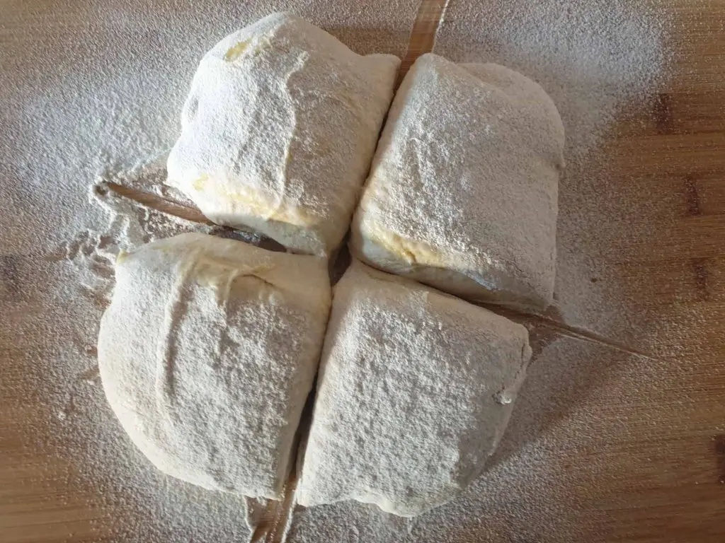 Dividing the dough into four bread rolls