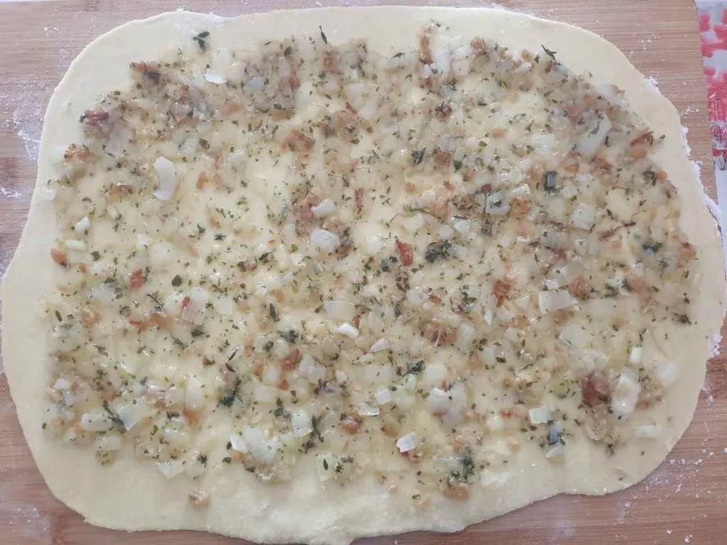 spreading the lard and onions onto the noodle dough