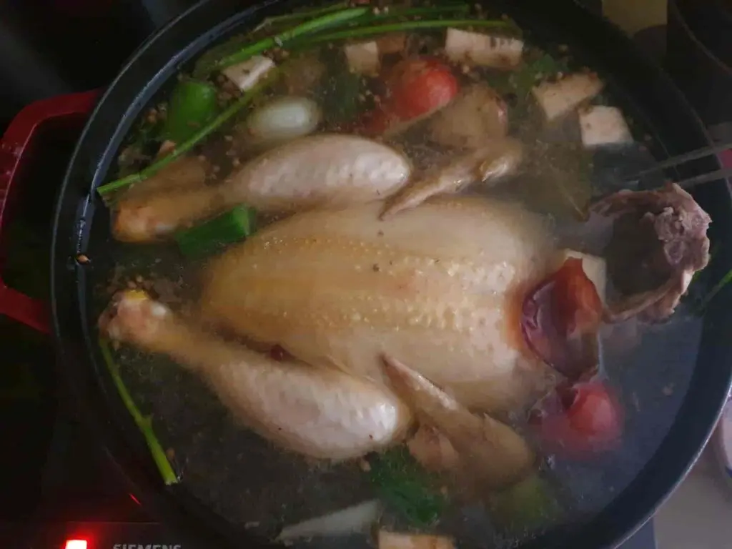 Cooking German chicken noodle soup in broth