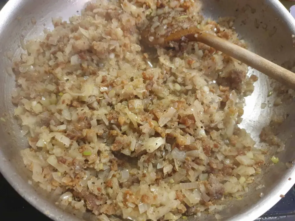Adding the onions to the pork fat